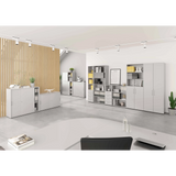Grauer Schrank mit Türen BETA 9 in einem hellen Büroraum mit weiteren Regalelementen von hjh OFFICE PRO