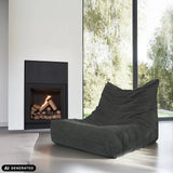 Grauer Loungesessel Sitzolo aus Cordstoff vor einem Kamin von hjh LIVING (KI-generiertes Bild)