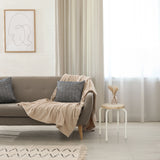 Sitzhocker ALRANDA in Weiß und Eiche neben einem Sofa von hjh LIVING